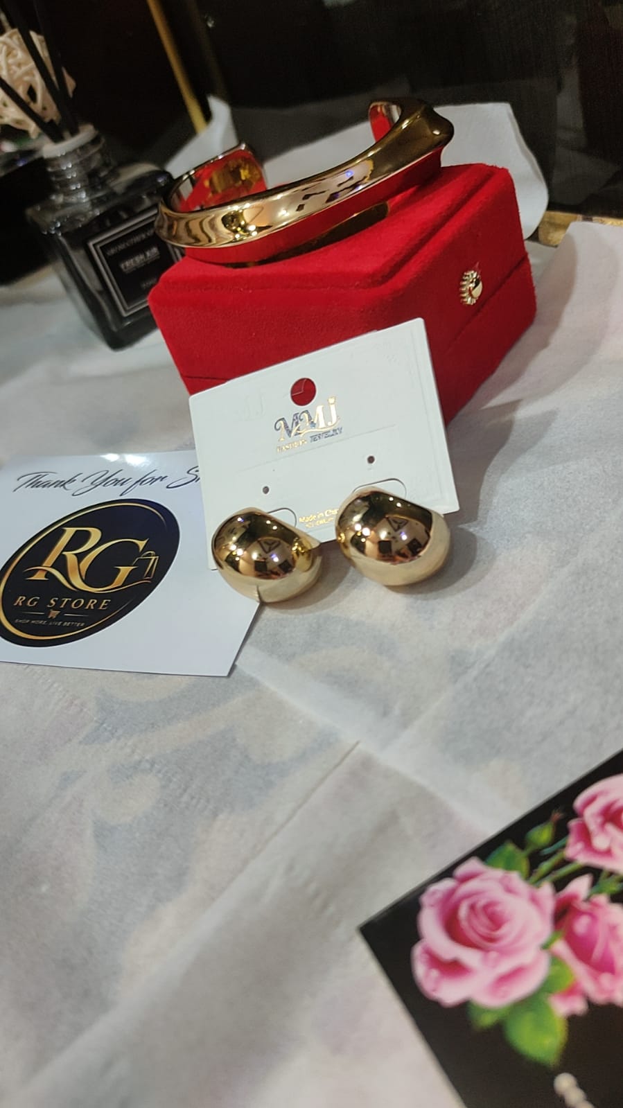 Golden statement bracelet and hoop earings
